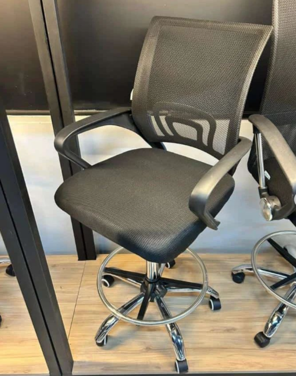 Ergonomic Mesh Teller Chair with adjustable height, cushioned seat, footrest, and swivel wheels.