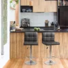 Black Modern Leather Bar Stool with faux leather upholstery and a natural iron frame, perfect for counter-height seating.