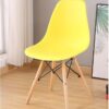 Colorful Plastic Eames Style Chairs with wooden legs in green, pink, blue, orange, and black, perfect for dining or office use.