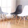 Colorful Plastic Eames Style Chairs with wooden legs in green, pink, blue, orange, and black, perfect for dining or office use.