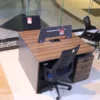 2-Person Modern Working Station with wood-grain finish, privacy divider, and lockable storage drawers for organized office spaces.