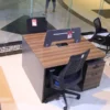 2-Person Modern Working Station with wood-grain finish, privacy divider, and lockable storage drawers for organized office spaces.