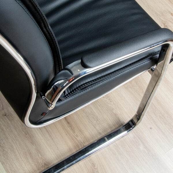 Stylish black leather visitor chair with chrome cantilever frame, ergonomic padded seat, and backrest, perfect for offices and reception areas.