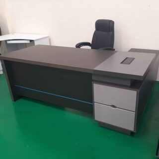 1.8m L-shaped executive desk with grommet and large storage space for office use.