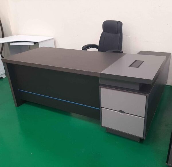 1.8m L-shaped executive desk with grommet and large storage space for office use.