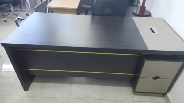 1.8m L-shaped executive desk with grommet and large storage space for office use.