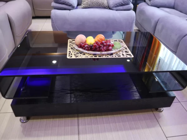 Black tempered glass coffee table with a sleek wooden base for office or living room décor.